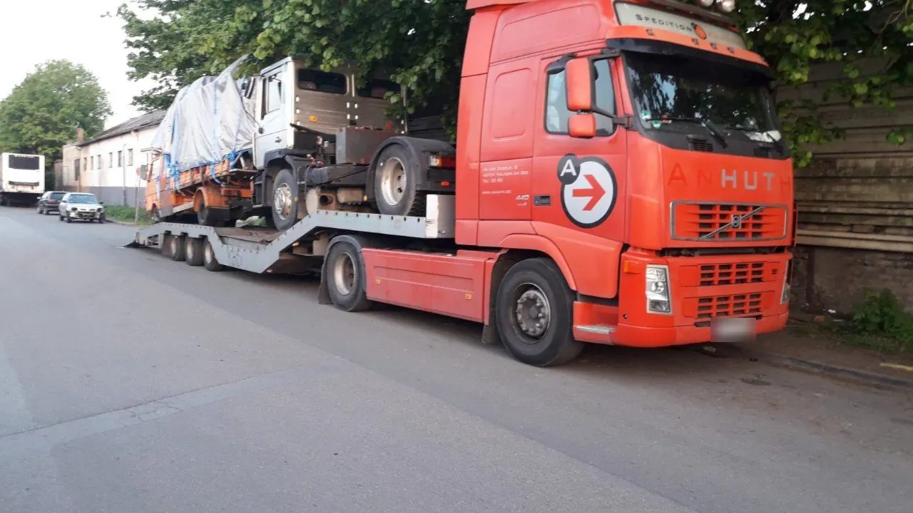 Car transporter loaded with two trucks for export